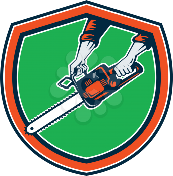 Illustration of hand holding chainsaw chain saw done in retro style on isolated  background set inside shield crest. 