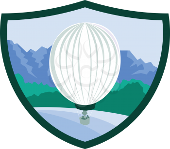 Illustration of a hot air balloon with sea, trees and mountains in the background set inside shield crest done in retro style. 