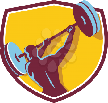 Illustration of a weightlifter lifting swinging barbell with both hands looking to the side viewed from rear set inside shield crest on isolated background done in retro style.