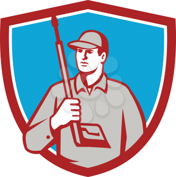 Illustration of power washer worker holding pressure washing gun on shoulder looking to the side viewed from front set inside shield crest on isolated background done in retro style. 