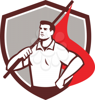 Illustration of a union worker holding red flag on shoulders with one hand on hips looking to the side set inside shield crest done in retro style. 