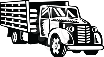 Retro woodcut black and white style illustration of a vintage classic American pickup truck with wood side rails viewed from front on low angle on isolated background.
