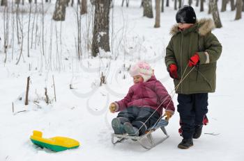 Royalty Free Photo of Children Outside With a Sled