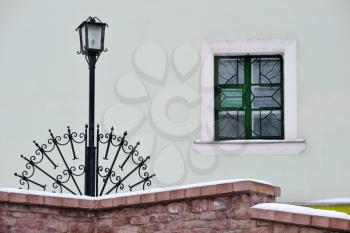 Royalty Free Photo of a Window, Brick Wall and Lamppost