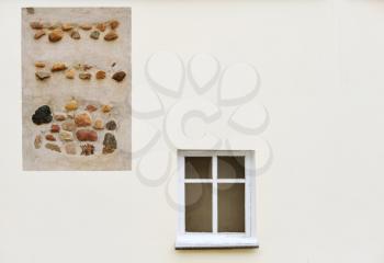 Royalty Free Photo of a Wall With a Stone Design and a Window
