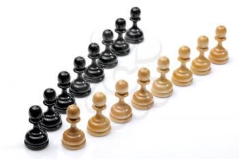 Several wooden chess pieces light and dark colors.