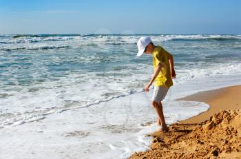 Royalty Free Photo of a Boy Playing at the Seashore