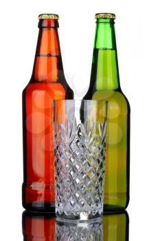Brown and green bottles of lager beer and glass, isolated on a white background.