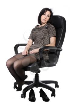 Girl in brown dress sitting in an office chair, isolated on a white background.