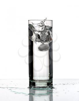 Glass with a water and ice, isolated on a white background.