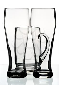 Glasses and a mug for beer on a white background, isolated