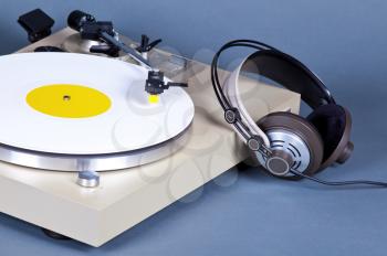 Analog Stereo Turntable Vinyl Record Player with White Disk and Headphones