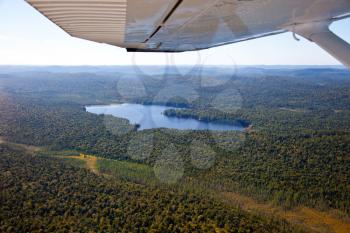 Adirondack forests, lakes, creeks and mountains aerial terrain view down from light aircraft