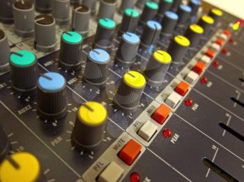 Audio mixing console board knobs and buttons closeup 
