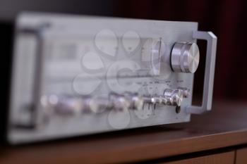 Vintage Stereo Receiver Standing on the Wooden Sideboard, Side View Closeup


