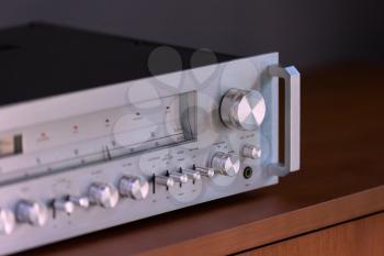 Vintage Stereo Receiver Standing on the Wooden Sideboard, Side View