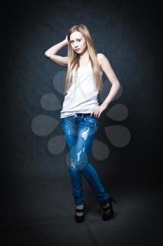 a young blonde wearing jeans and jacket full body shot