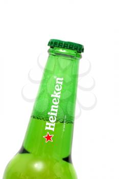 Closeup of a heineken green beer bottle cap and neck  Bottle is at an angle focus on the bottle cap. Shallow Depth of Field.