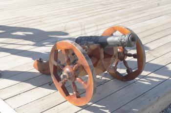 Antique cannon outdoors at a day on wooden planks ready for shot
