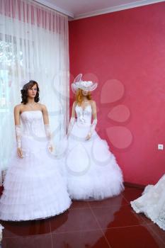 Shop window with wedding dresses on mannequins