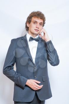 Evening fashion suit. Portrait of handsome man in the black suit with bow tie