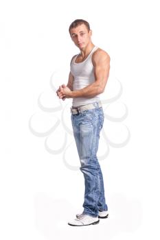 Sexy fashion portrait of a hot male model in stylish jeans with muscular body posing in studio on white