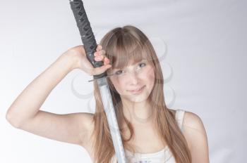 Beautiful blonde lady with japanese sword isolated