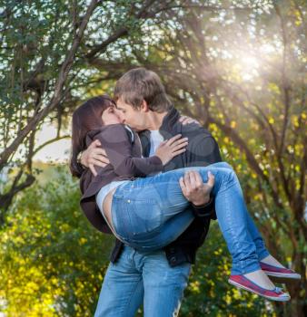 Young happy attractive couple kissing, outdoors
