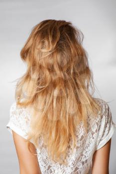 back view of the blond haired female, head and  shoulders shot