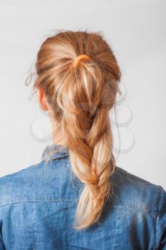 back view of the blond haired female with braid (pigtale), head and  shoulders shot