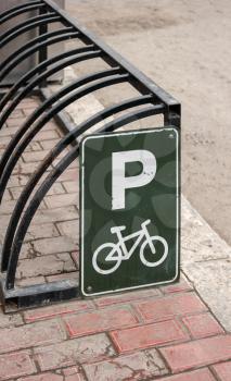 Bike parking. Bicycle parking frame, rack wheelbender with sign.