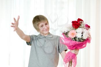 Royalty Free Photo of a Young Man Holding a Bouquet