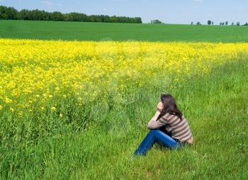 Royalty Free Photo of a Woman Sitting in a Field 