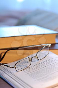 Royalty Free Photo of a Pair of Glasses on a Book