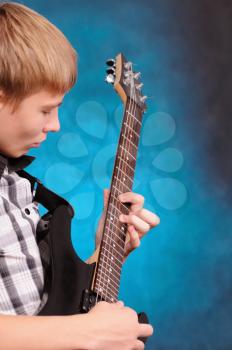 Royalty Free Photo of a Teenager Playing Guitar