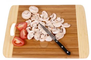 Royalty Free Photo of Mushrooms and Tomatoes on a Cutting Board                                 