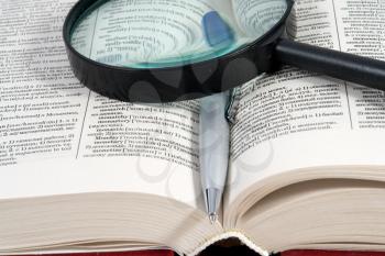 Royalty Free Photo of a Magnifying Glass on a Book