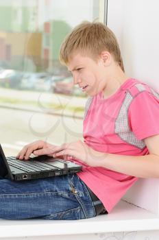 Royalty Free Photo of a Teenager With a Laptop