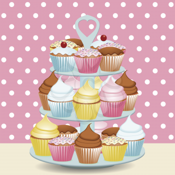 Decorated cupcakes on a stand with a polka dot background