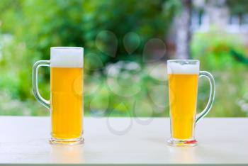 Royalty Free Photo of Two Glasses of Beer Outside