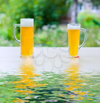 Royalty Free Photo of Two Glasses of Beer Outside