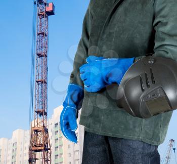 Royalty Free Photo of a Welder Standing In Front of a Building
