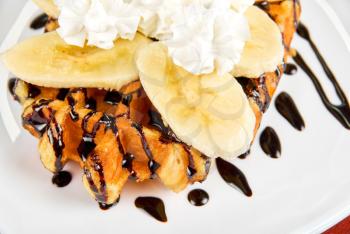 Royalty Free Photo of a Waffle With Bananas and Whip Cream