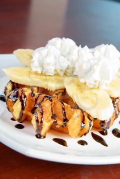 Royalty Free Photo of a Waffle With Bananas and Whip Cream