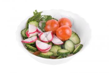 Salad from tomatoes cucumbers and radish on white