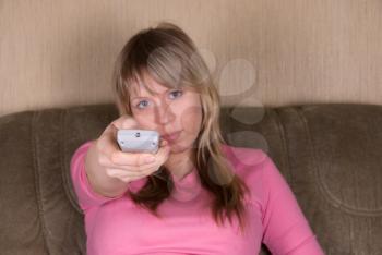 Royalty Free Photo of a Woman Sitting on the Couch Watching Television
