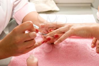 Royalty Free Photo of a Woman Getting a Manicure