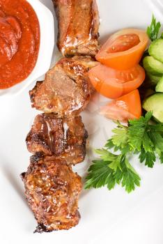Royalty Free Photo of Fried Kebab Meat With Vegetables and Sauce