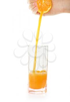 Royalty Free Photo of a Hand Squeezing an Orange into a Glass