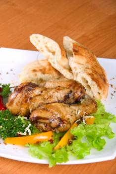 Royalty Free Photo of Roasted Chicken Drumsticks With Salad